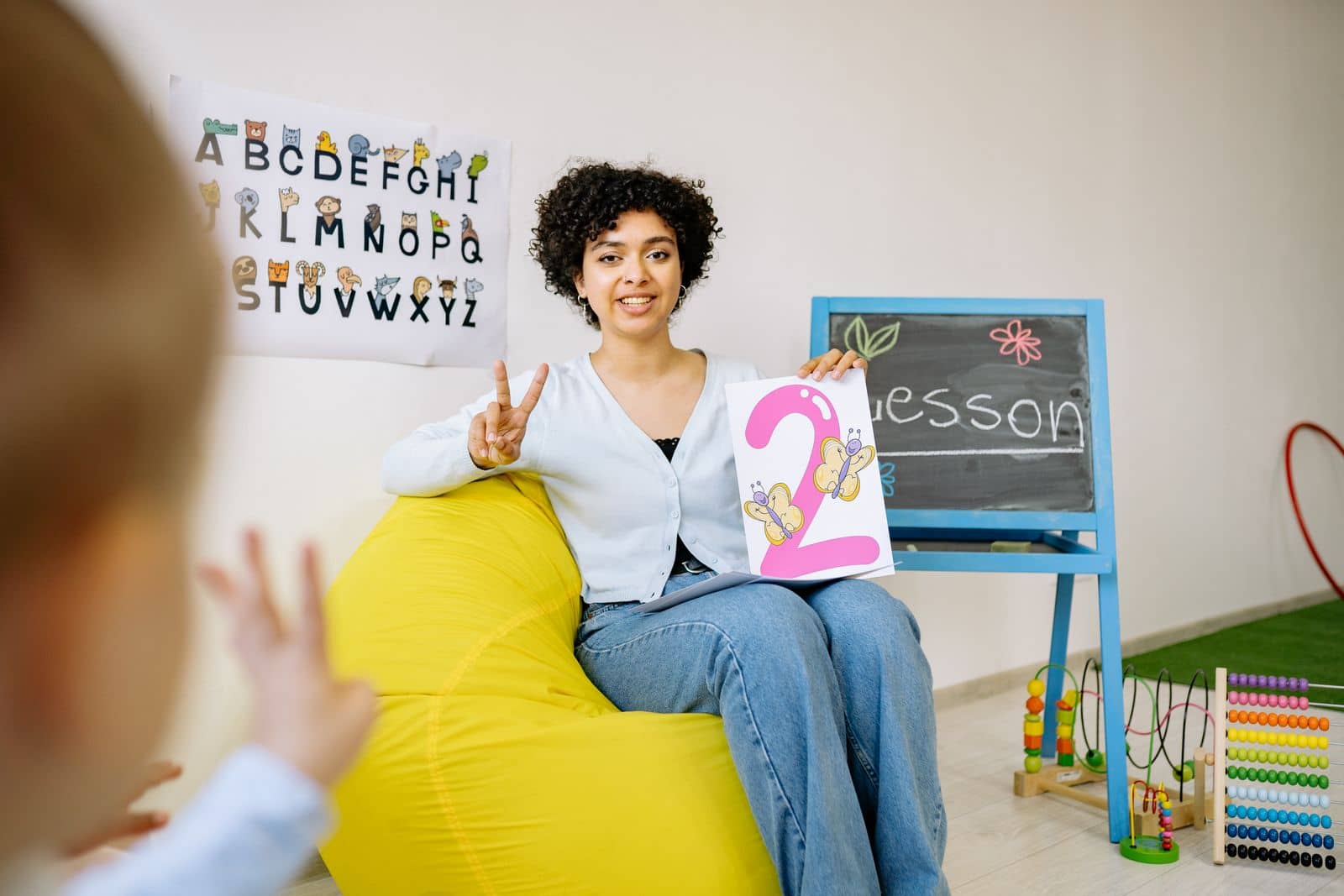 Teacher interacting with young children in a nurturing preschool classroom
