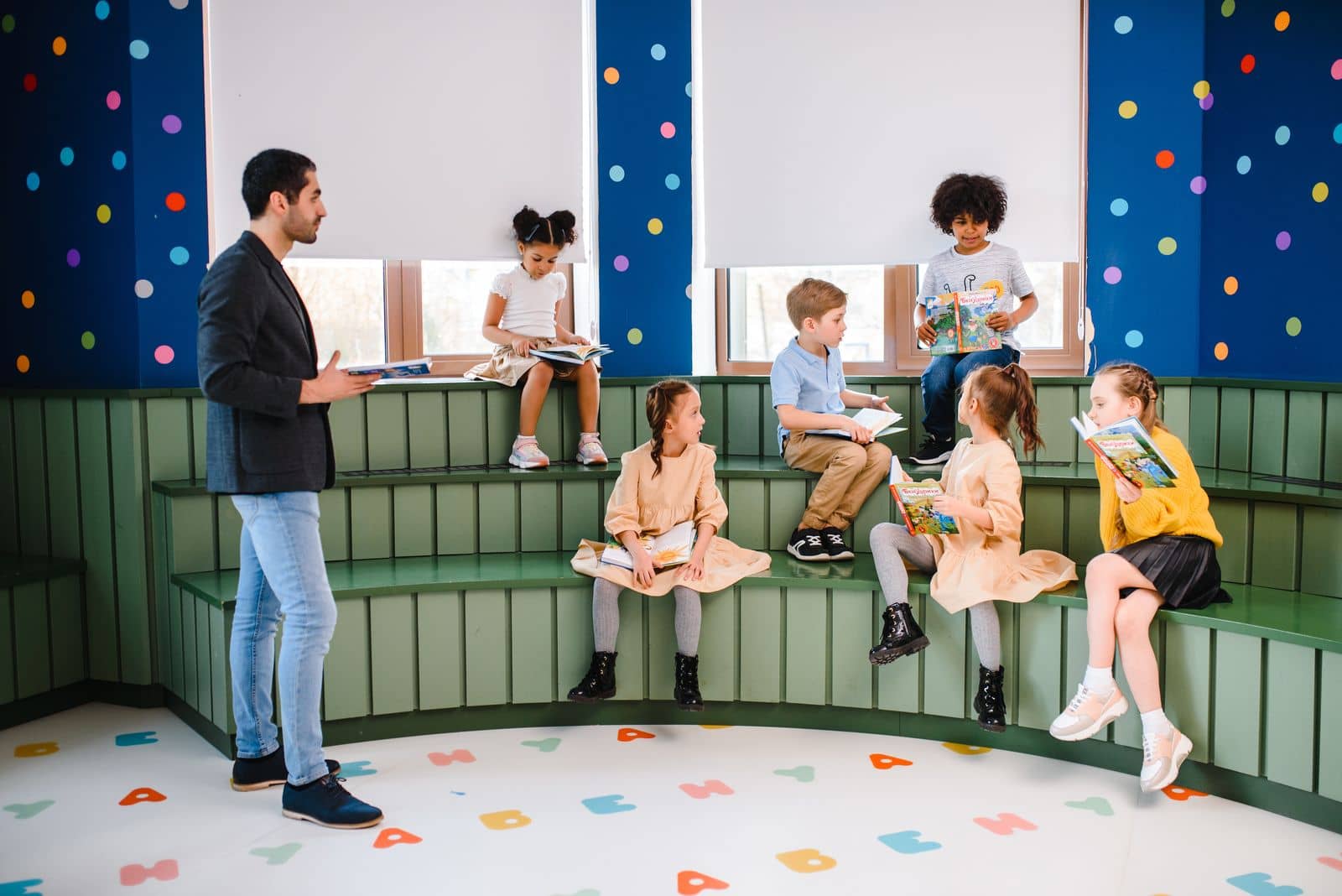 Diverse group of children learning together with their teacher in a colorful, inclusive classroom