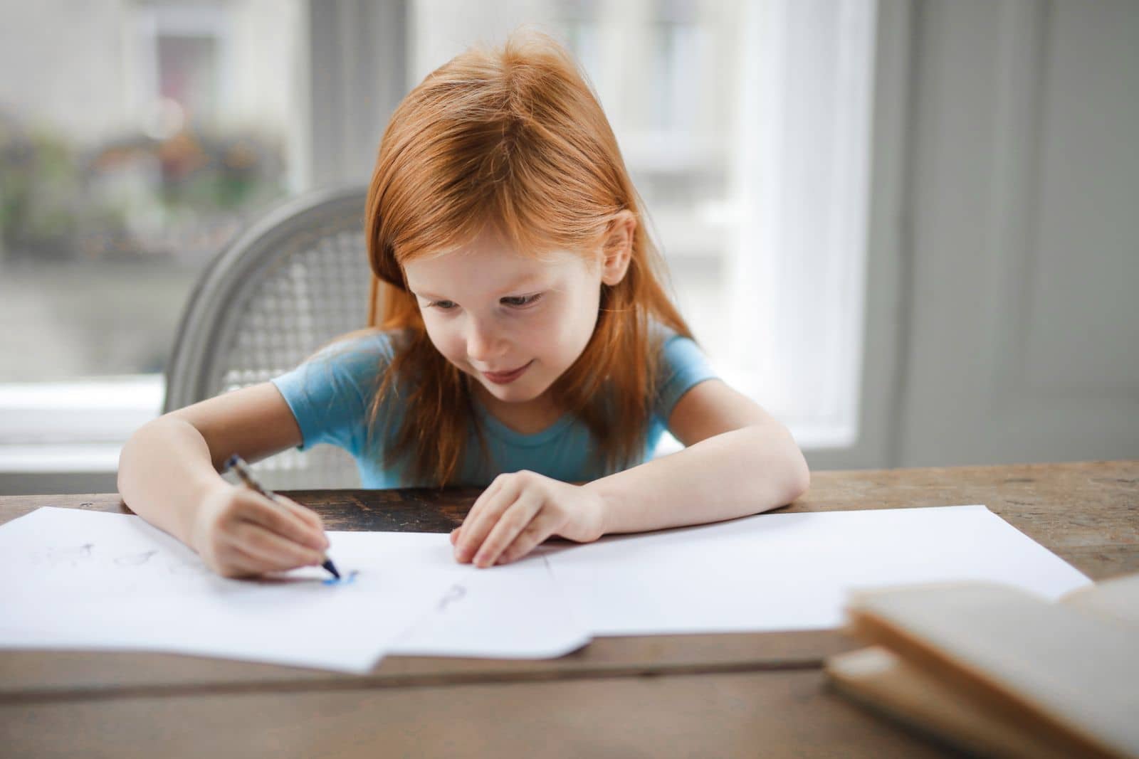 Older kindergarten children focused on reading and writing